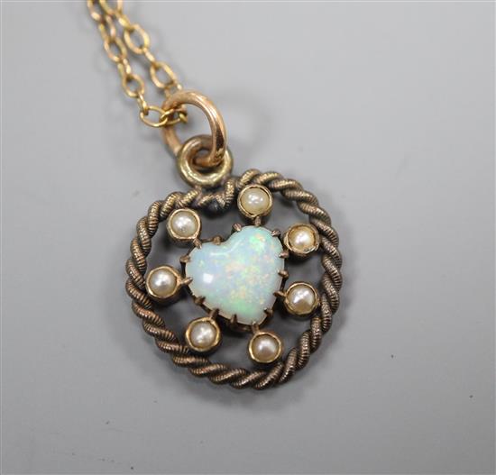 An Edwardian heart shaped white opal and seed pearl set heart shaped pendant on a fine link chain, pendant 22mm.